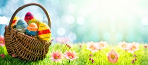cestino con uova pasquali in un campo adorno di fiori